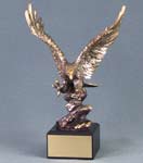 Image of a large gold eagle in flight on a square black base